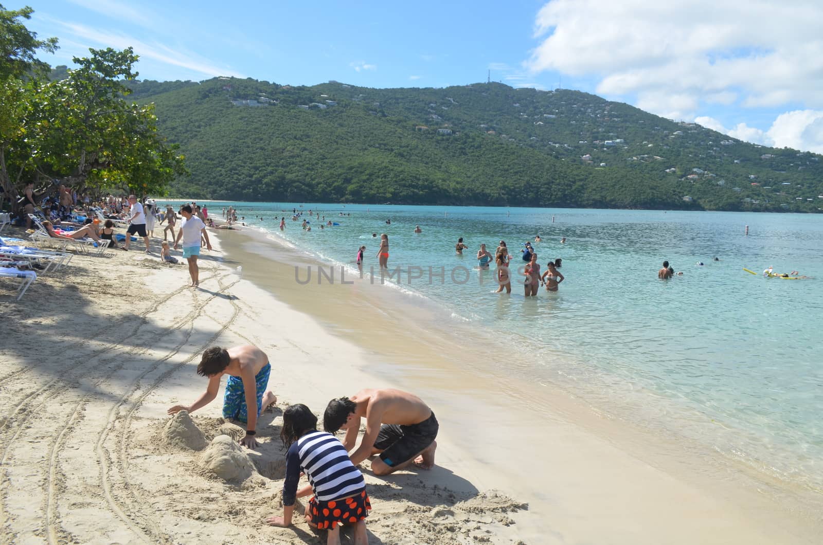 Children digging sand castles on the beach at Magens Bay,St.Thomas,U.S.Virgin Islands on 24 December 2015