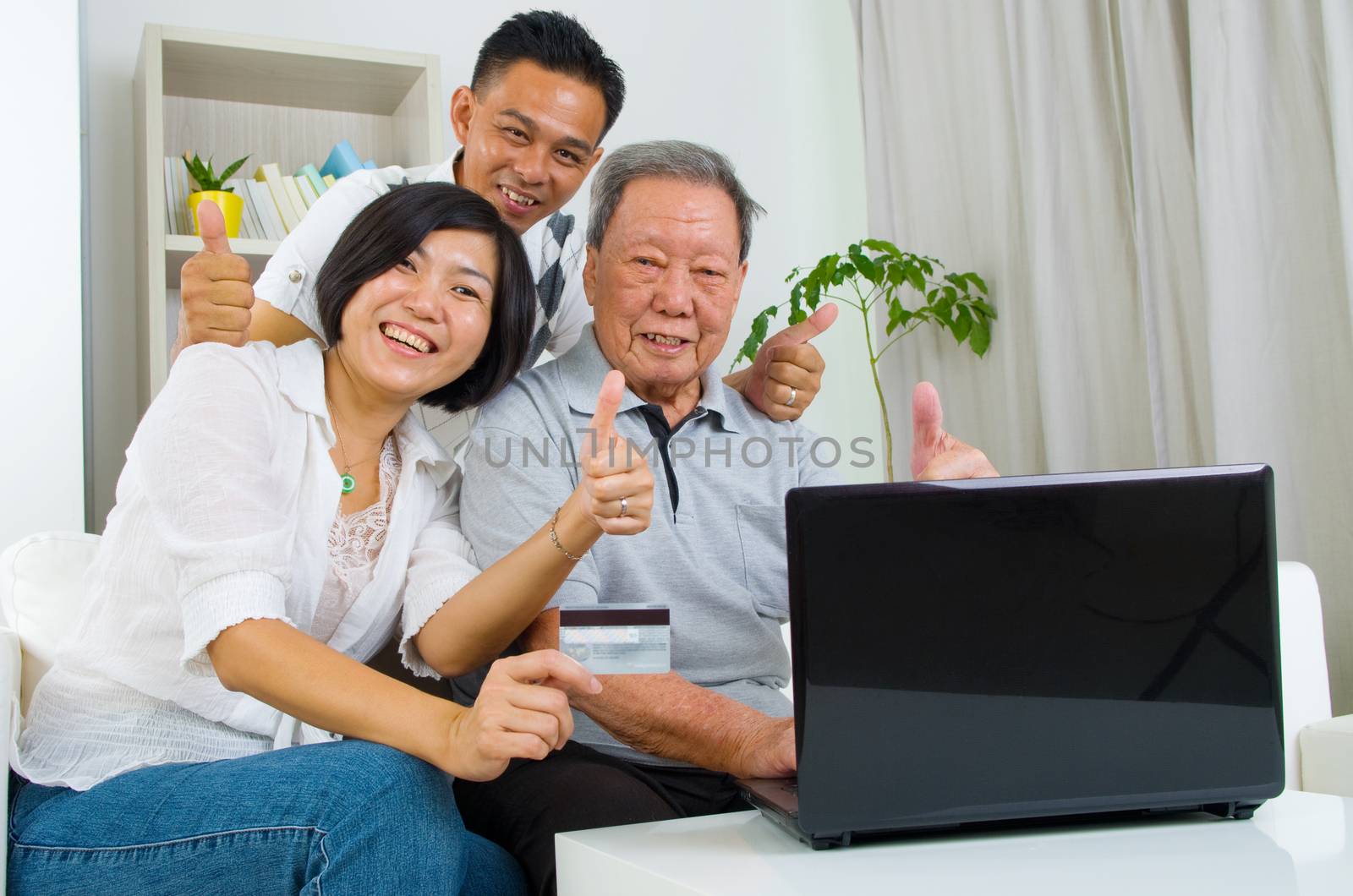 Asian senior man learns to use online internet banking