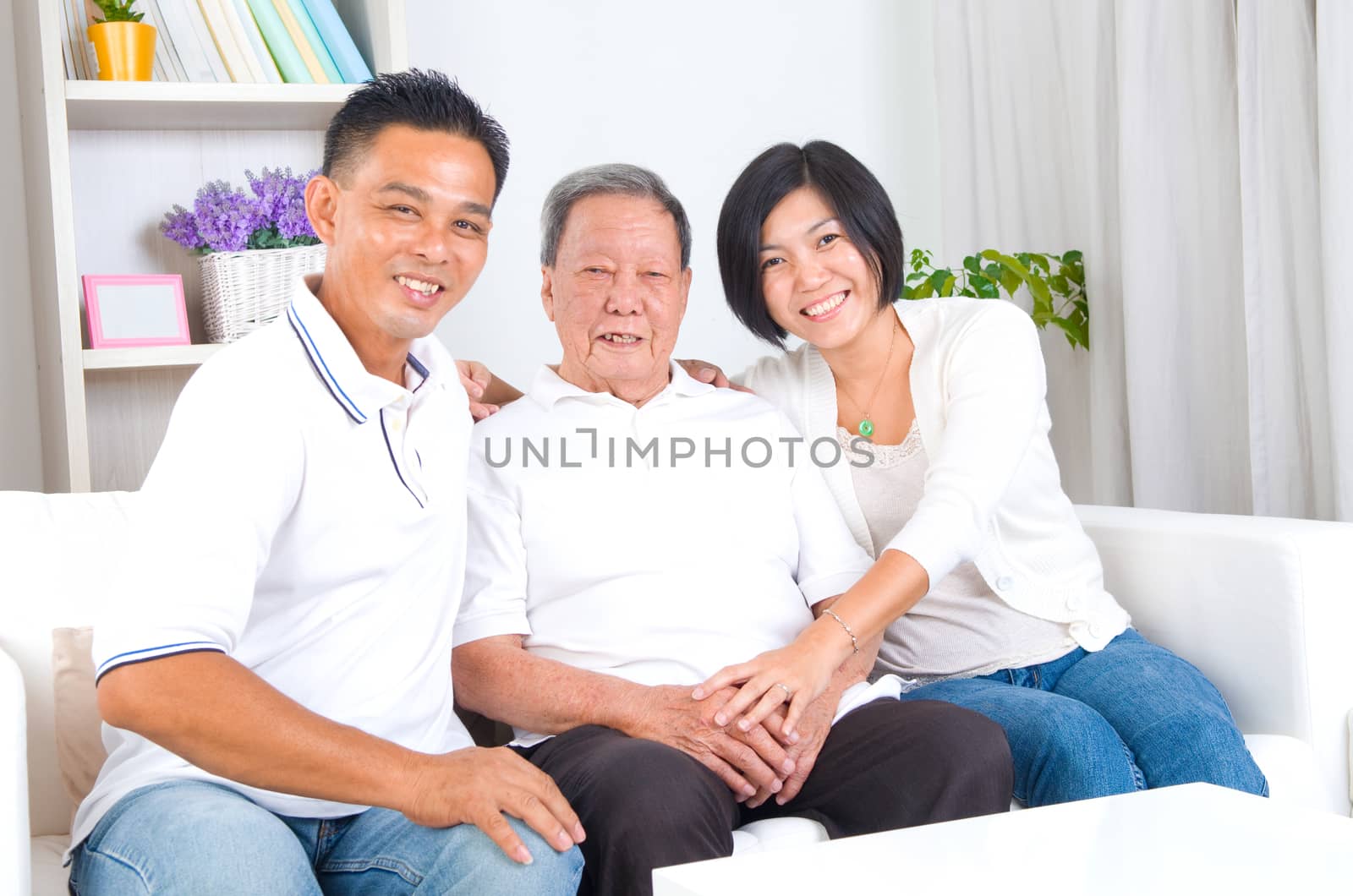 Asian senior father with his adult son and daughter at home. Family living lifestyle.