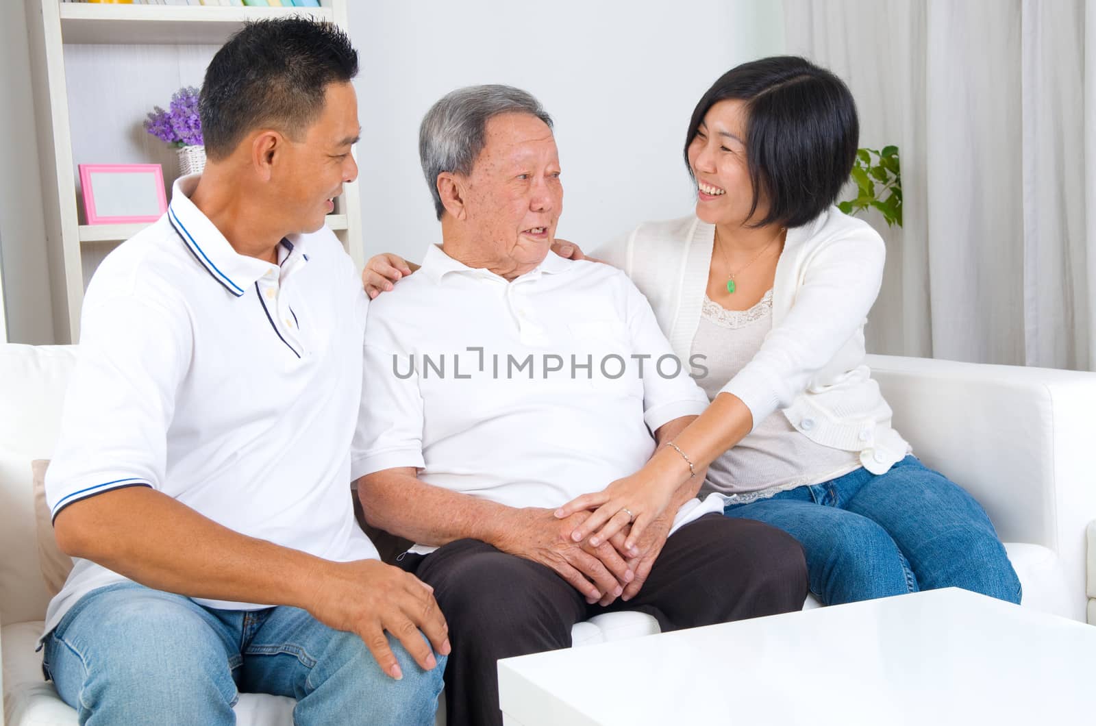 Asian senior father with his adult son and daughter at home. Family living lifestyle.