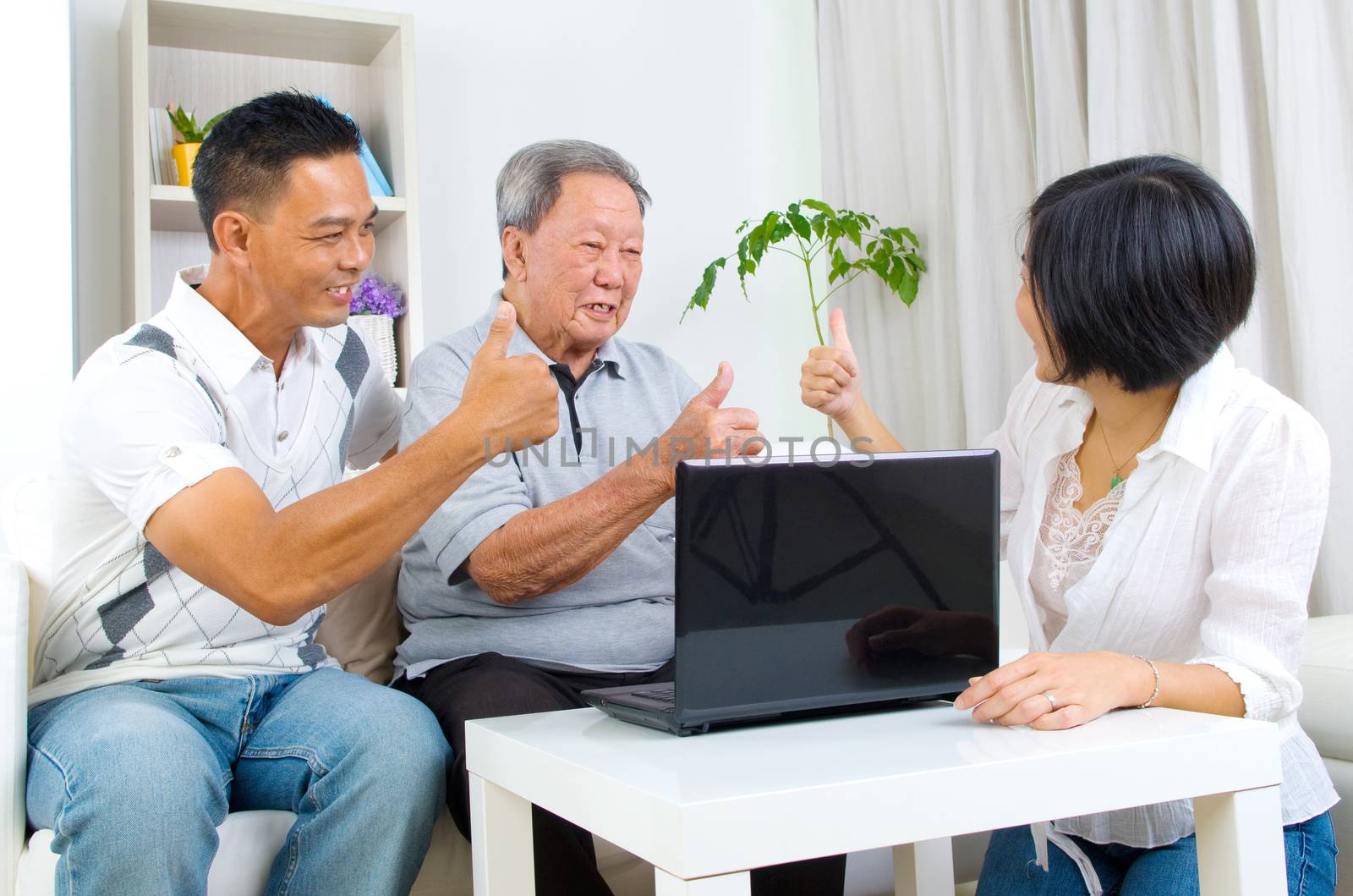 Asian senior man learns to use tablet computer