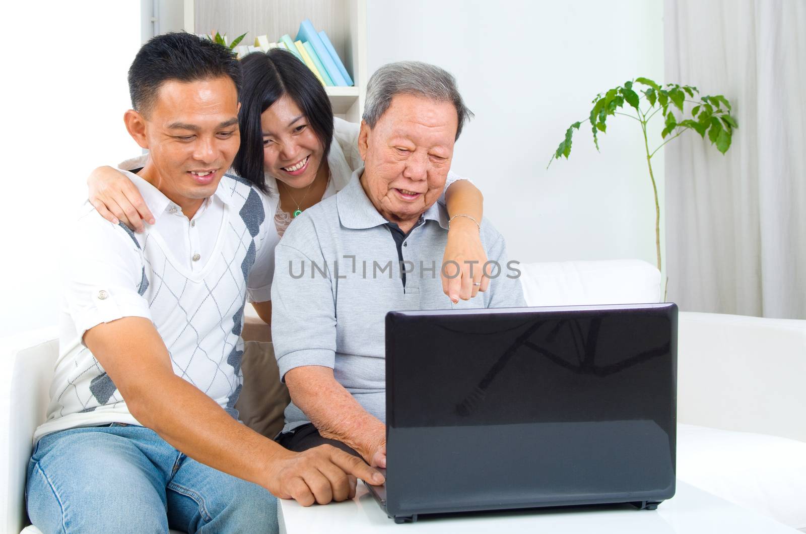 Asian senior man learns to use tablet computer