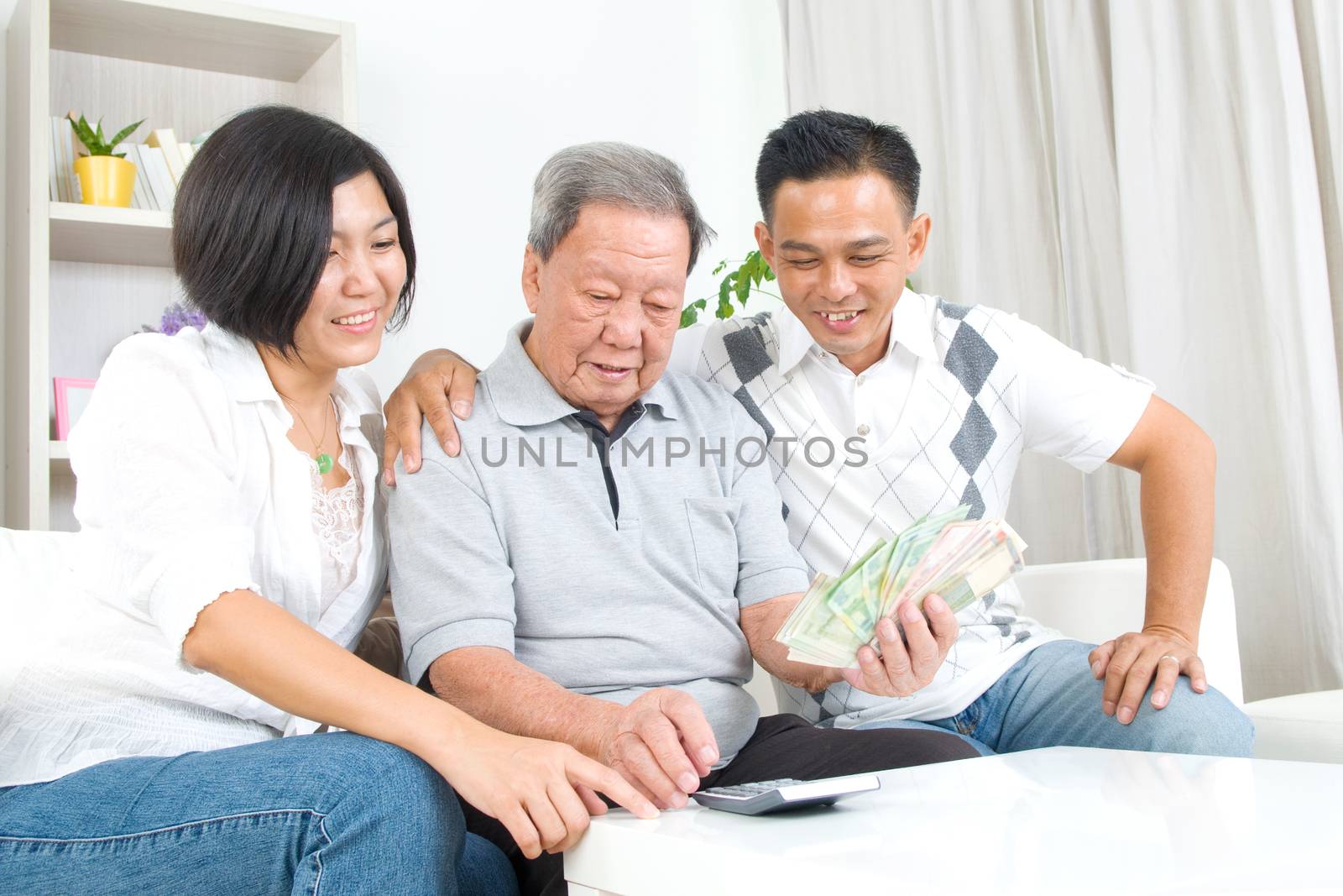 Asian senior man and children calculating money at their home