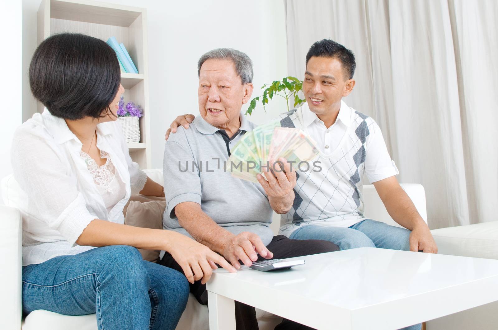 Asian senior man and children calculating money at their home