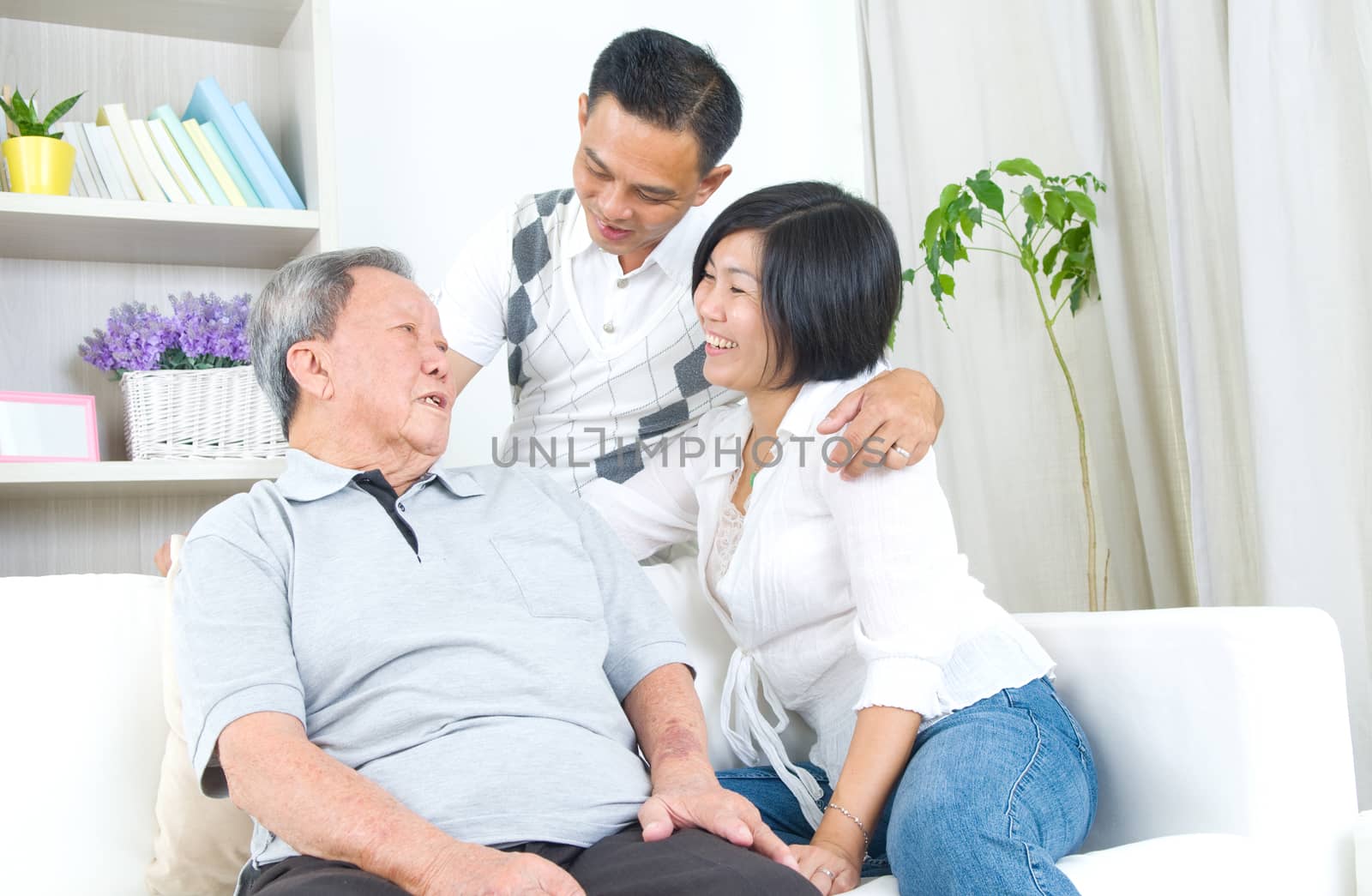 Asian senior father with his adult son and daughter at home. Family living lifestyle.