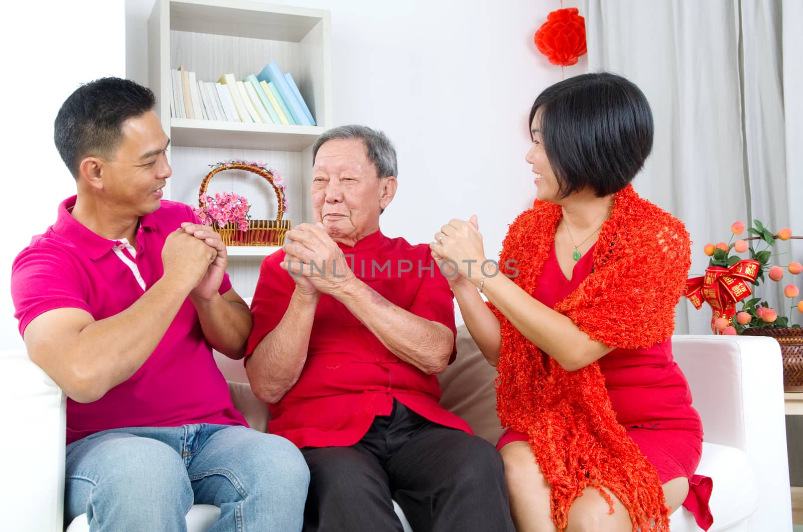 Asian senior man and children celebrating chinese new year