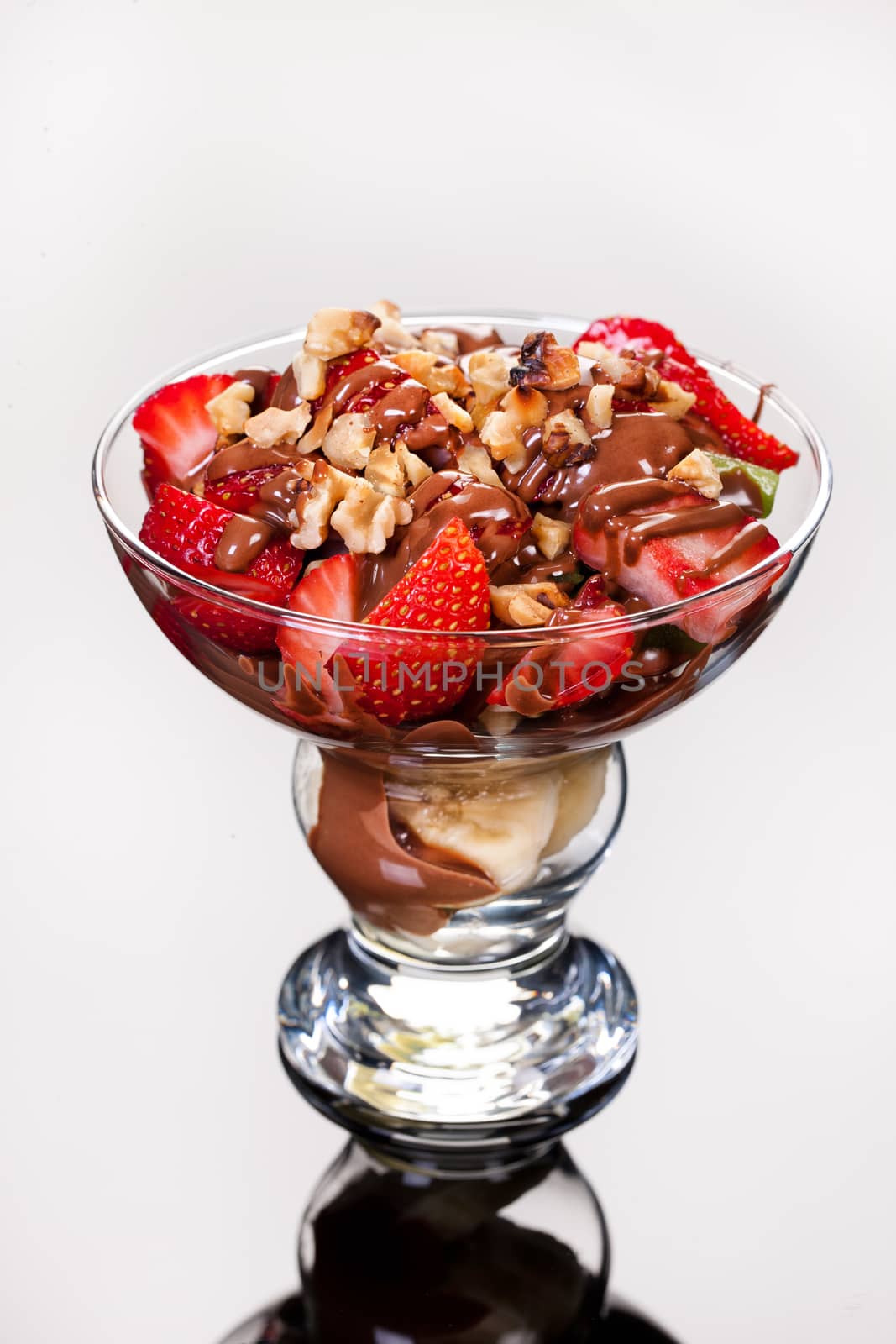 Slices of chocolate in a glass on a glass background
