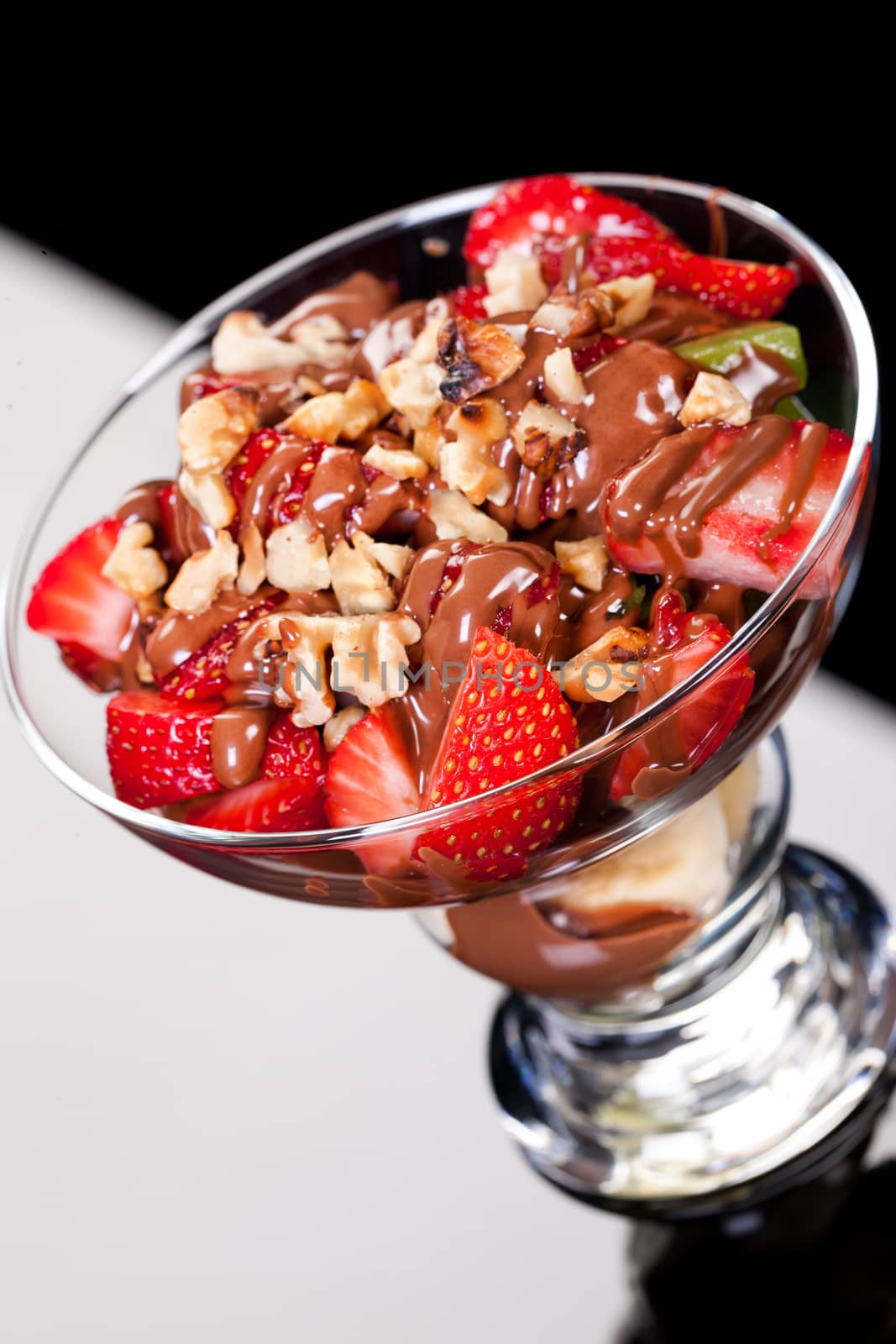 Slices of chocolate in a glass on a glass background