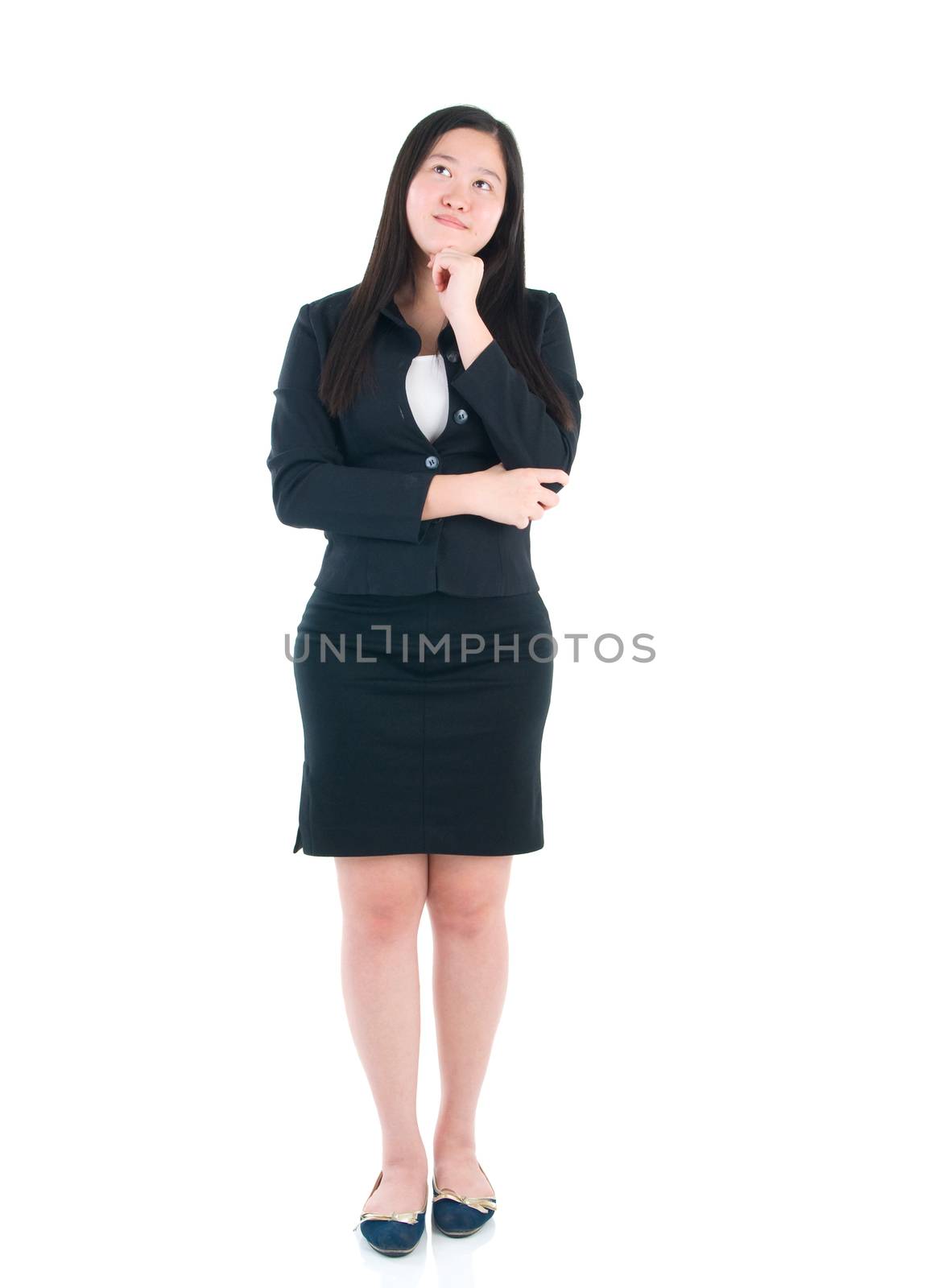 Full body Asian business woman standing on plain background.