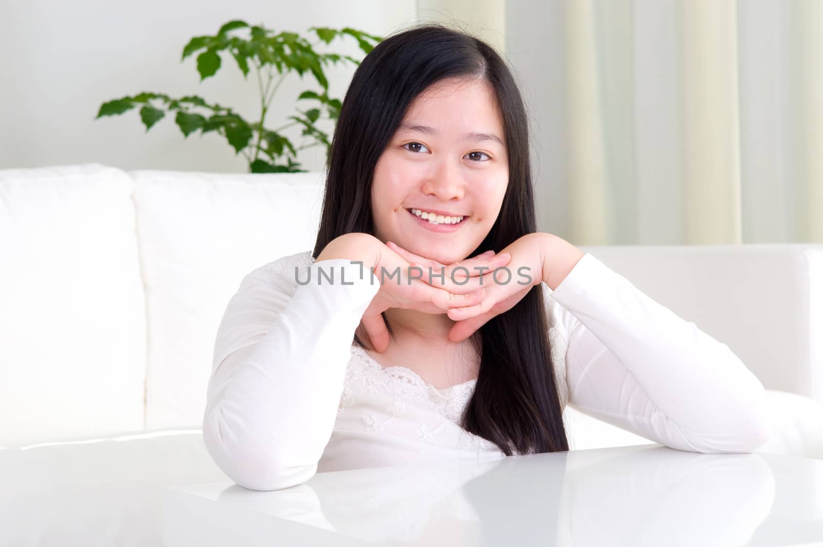 Portrait of attractive Asian girl smiling. Young woman indoors living lifestyle at home.
