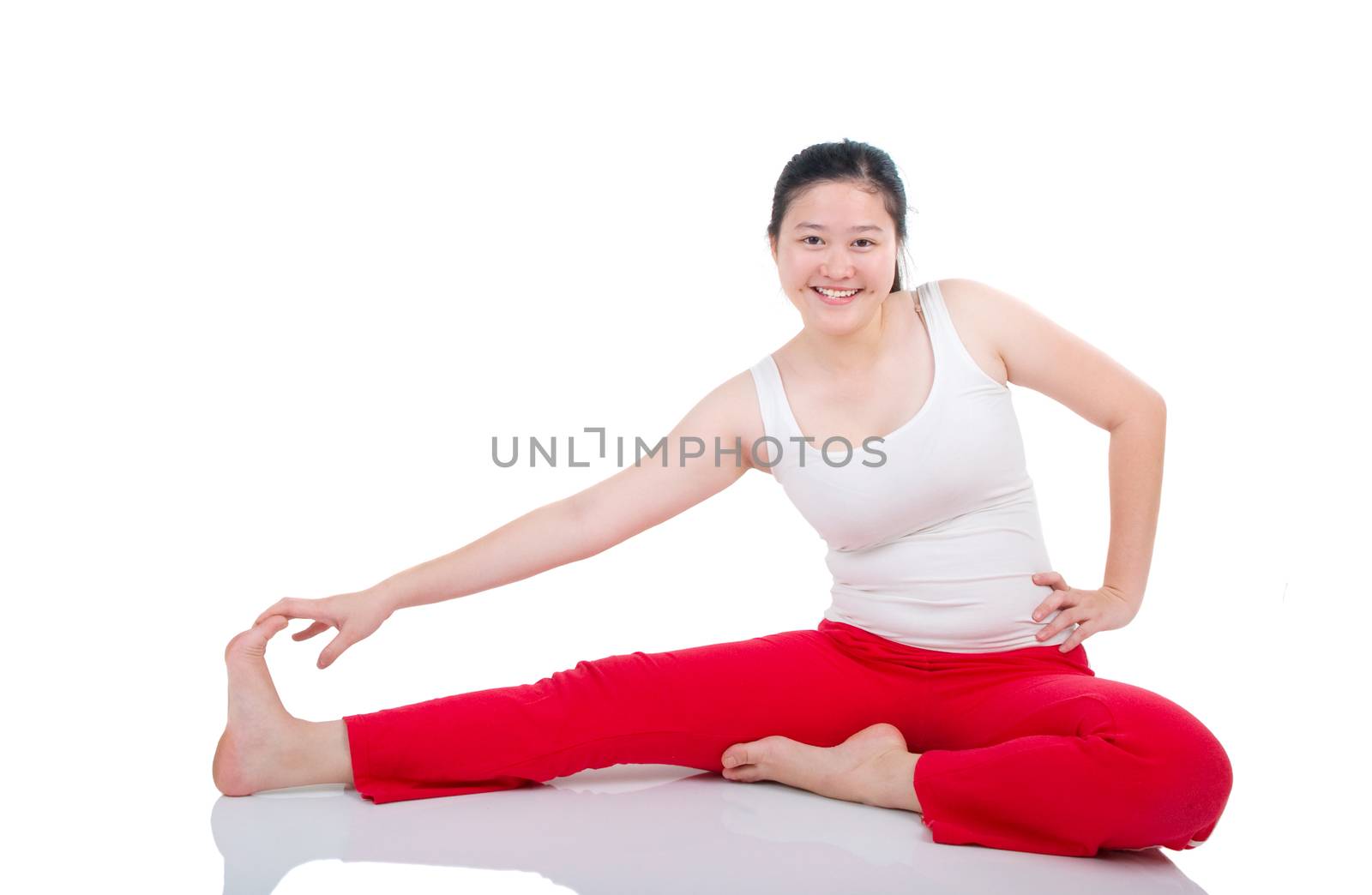 beautiful young woman stretching on the floor