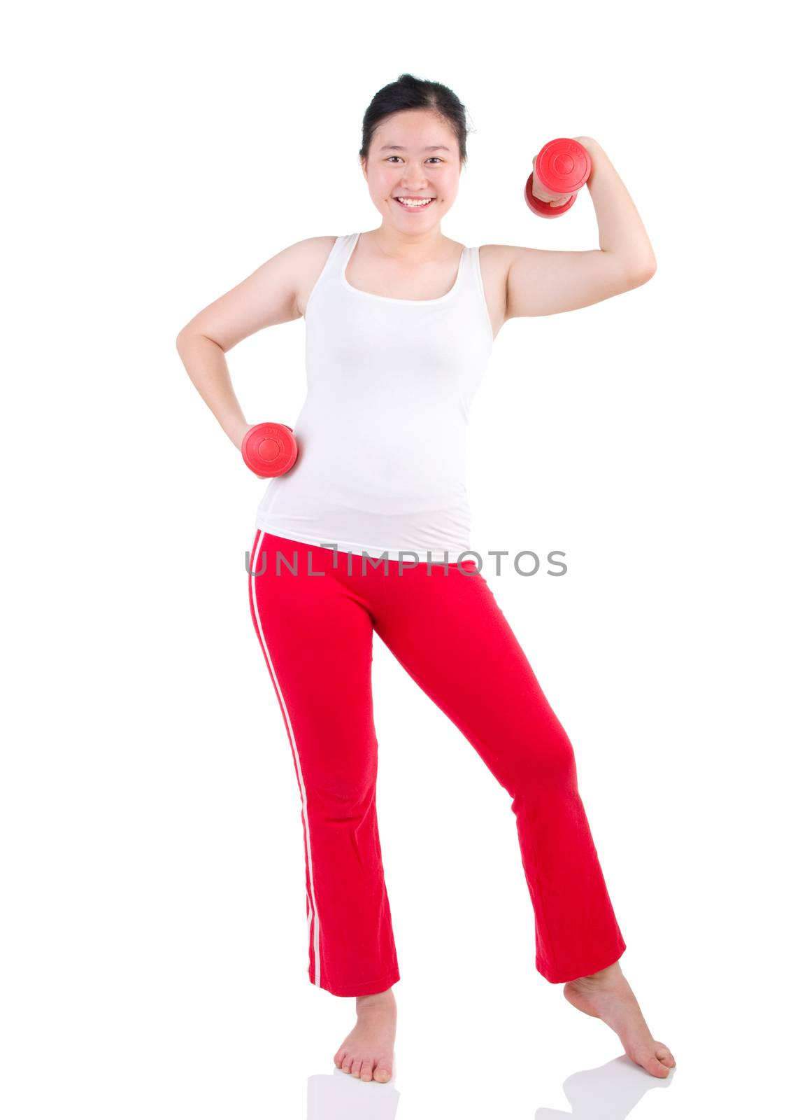 happy young woman exercising with dumbbells