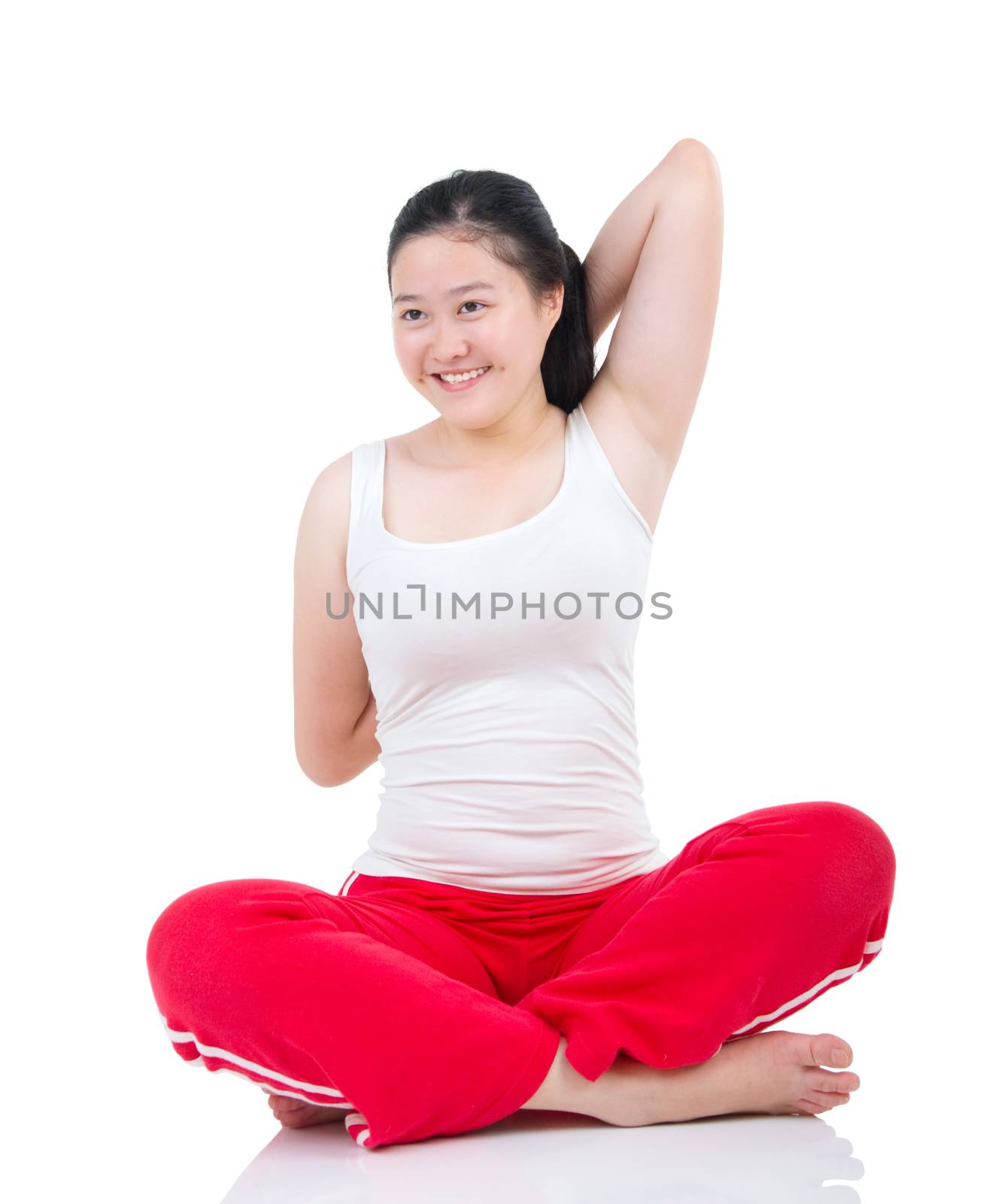 Beautiful fit woman stretching her arm and smiling