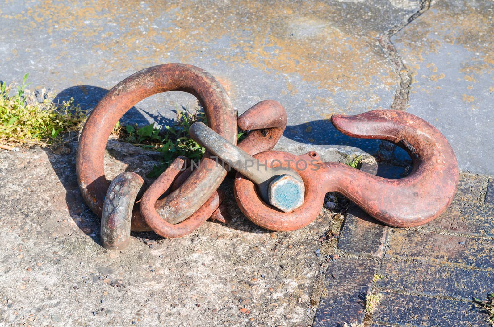 Mooring strap, steel hook and eye at a quay for securing larger motor ships.