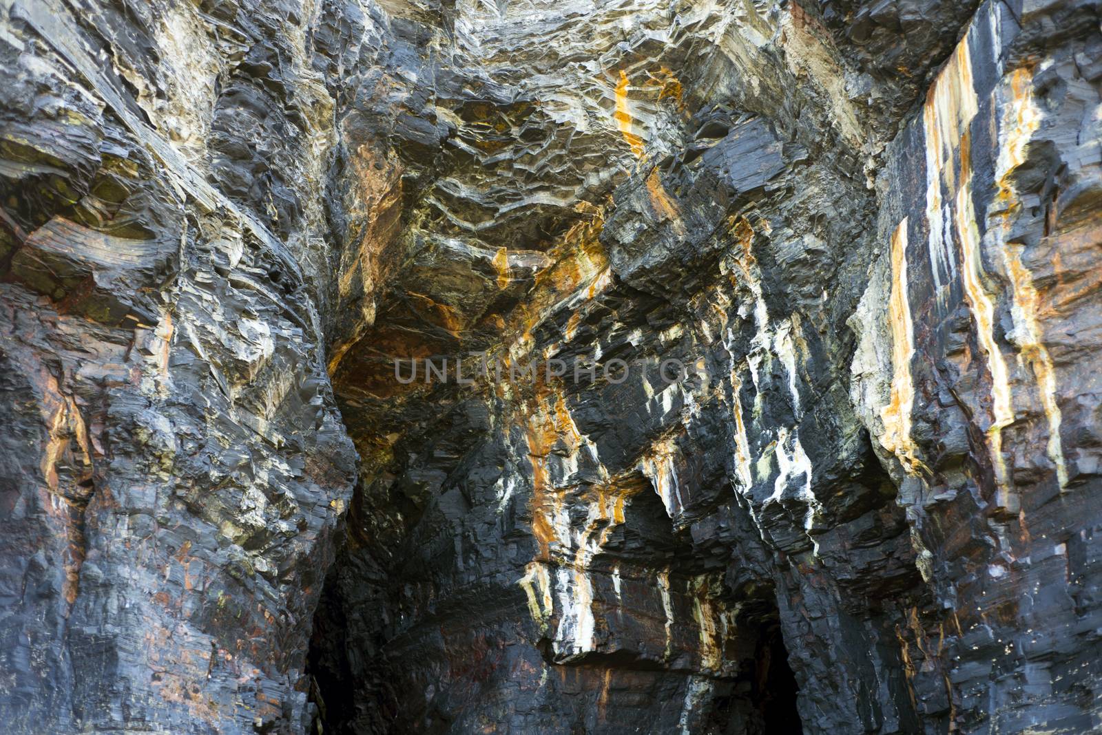 cliff face on the wild atlantic way at low tide by morrbyte