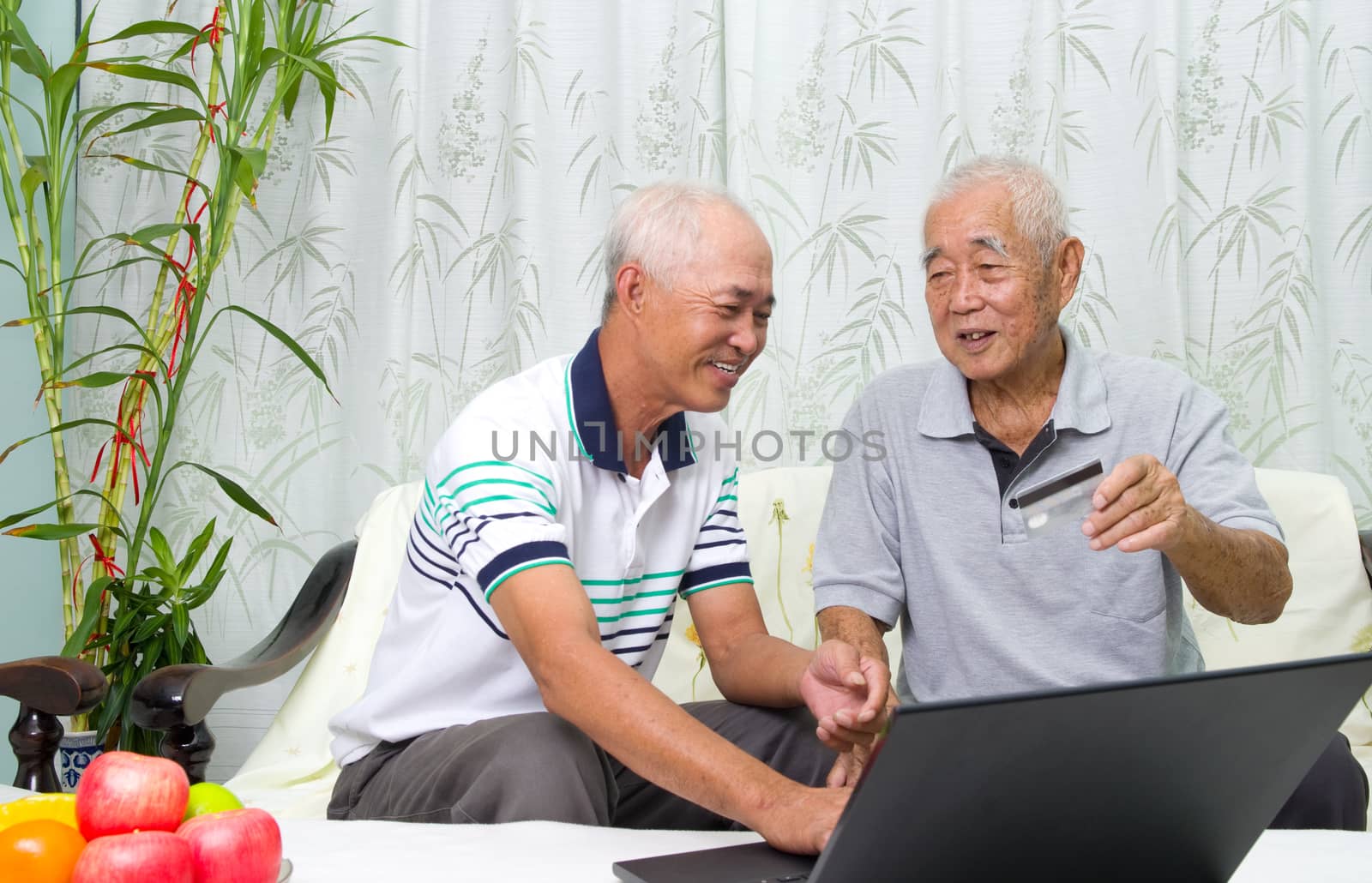 Asian senior man learns to use online internet banking