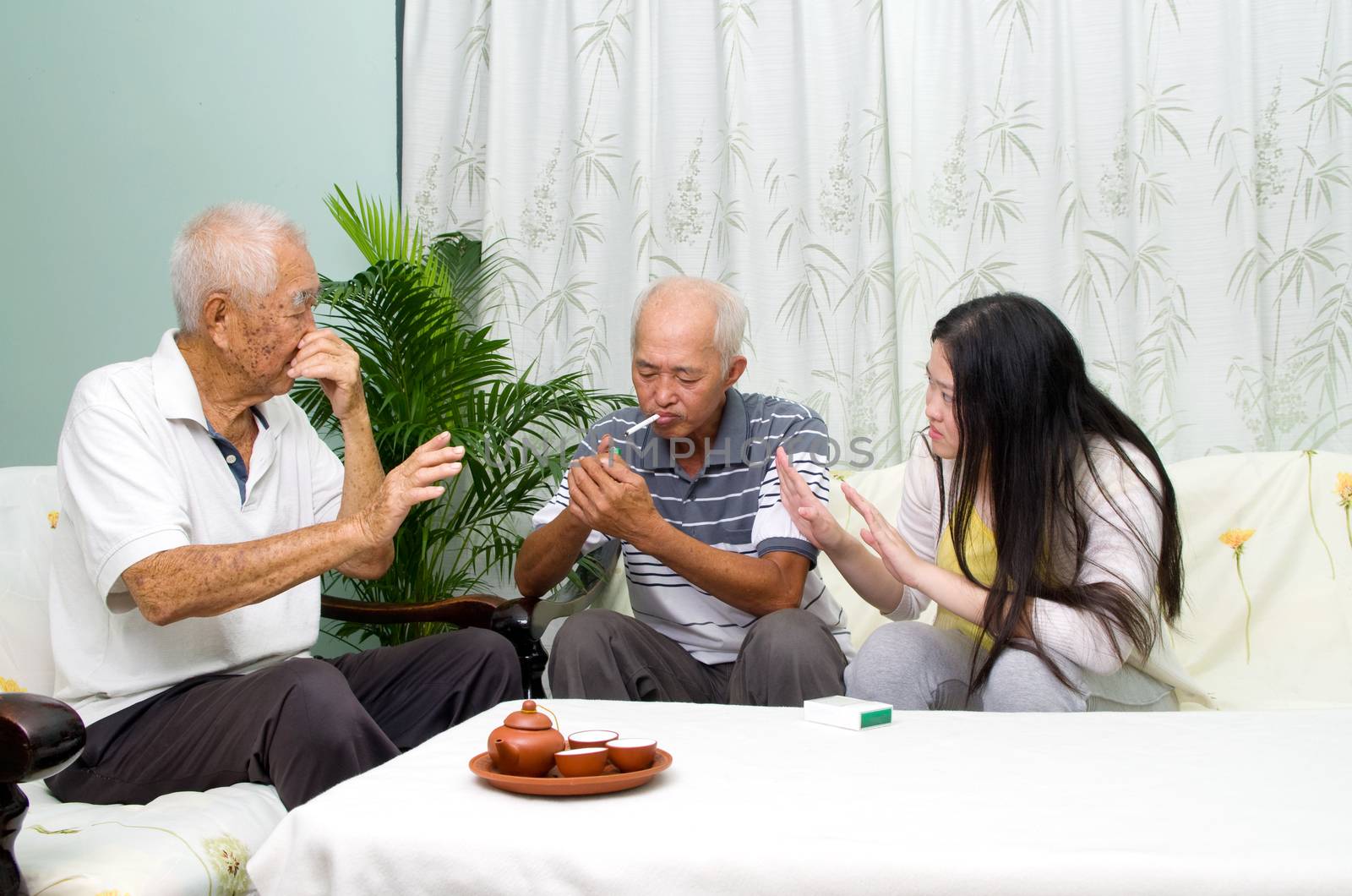 Asian father smoking at home. Unhealthy lifestyle or stop smoking concept photo.