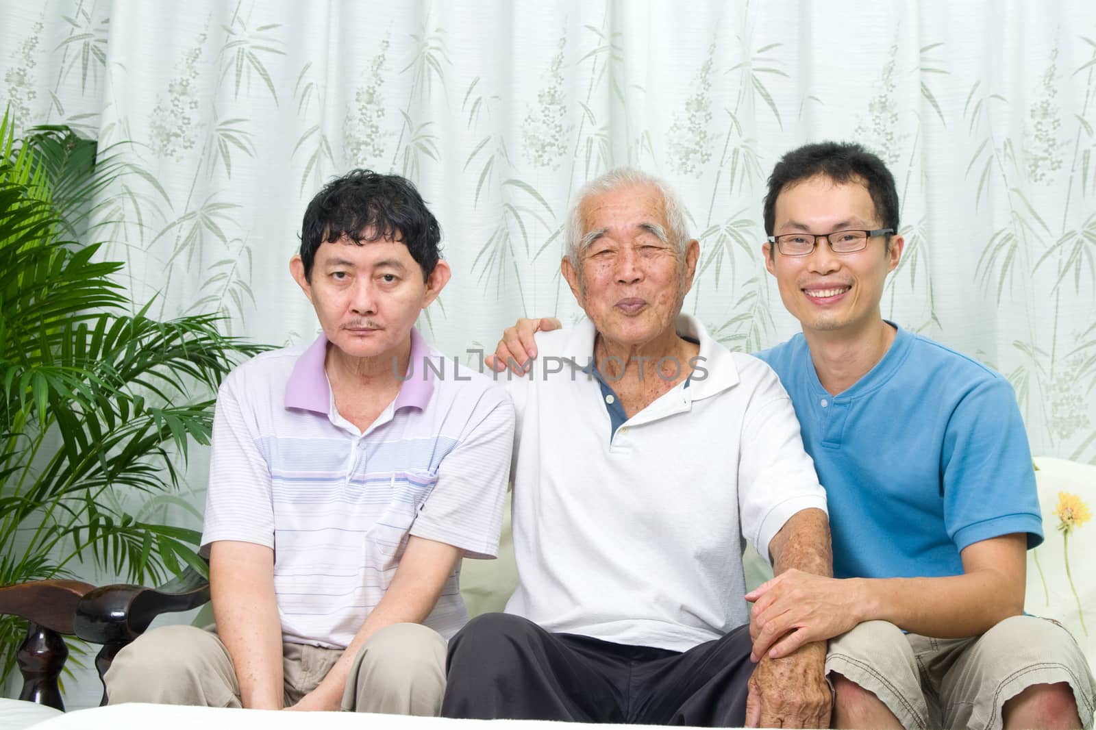 Asian senior father with his adult sons at home. Family living lifestyle.