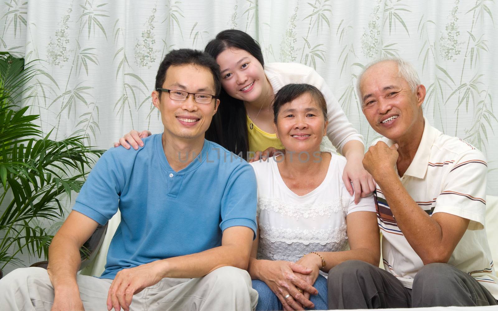 Asian parent with their adult sons and daughter at home. Family living lifestyle.