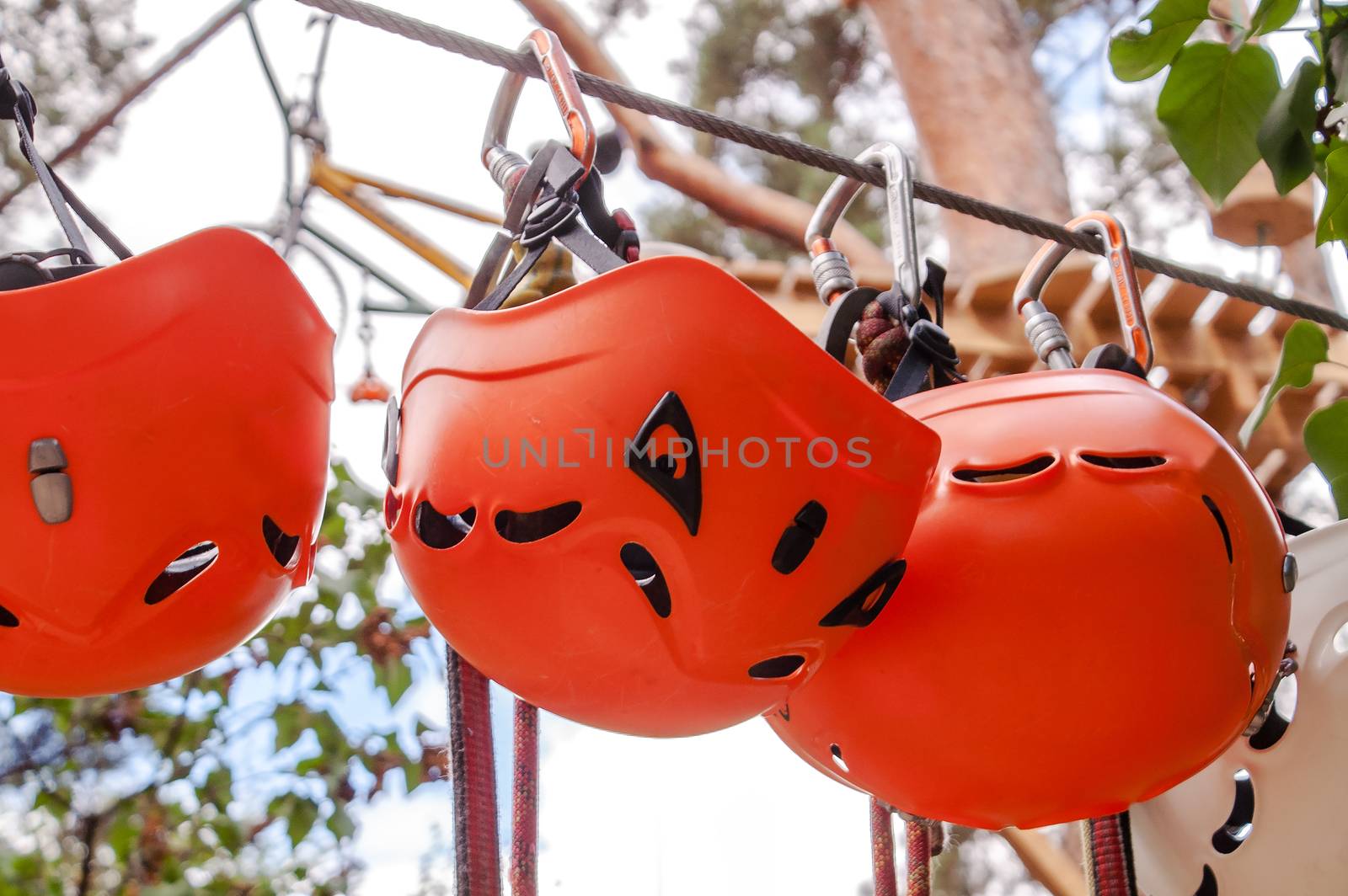 orange helmet hanging on for skalalazaniya carabiner and rope park  