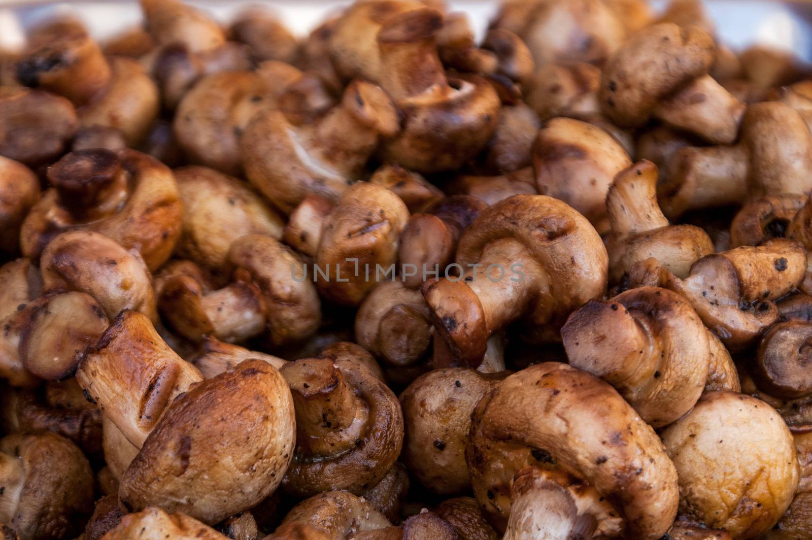 it is a lot of tasty fried mushrooms of shampyon a grill