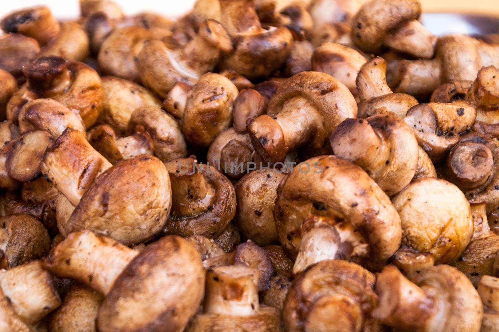 it is a lot of tasty fried mushrooms of shampyon a grill