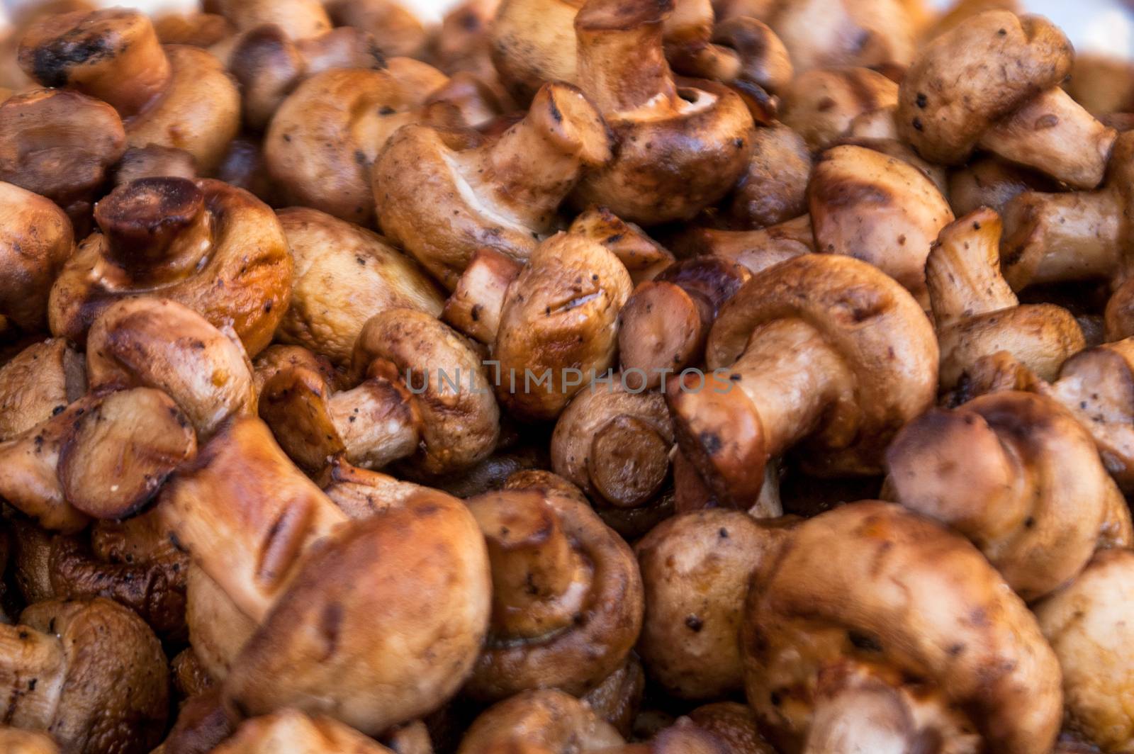 it is a lot of tasty fried mushrooms of shampyon a grill