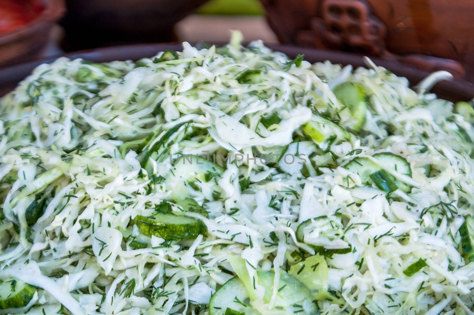 salad from a fresh white cabbage with cucumbers