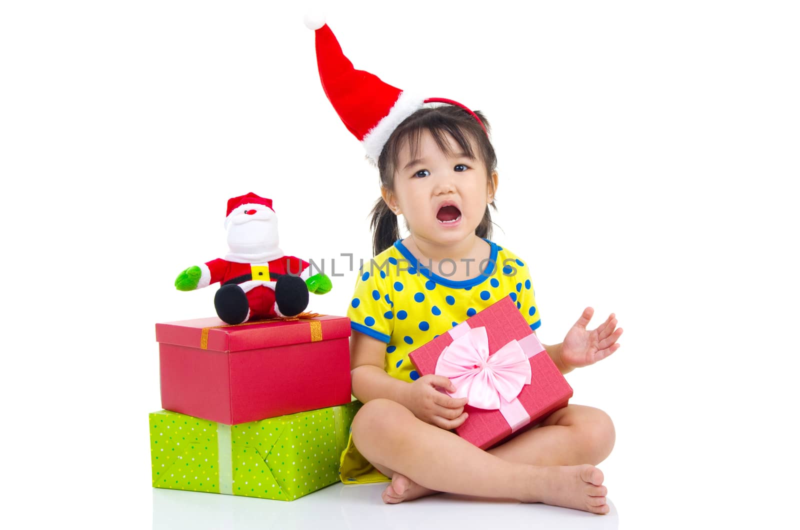 Little Asian girl in Santa hat and Christmas gift box isolated on white