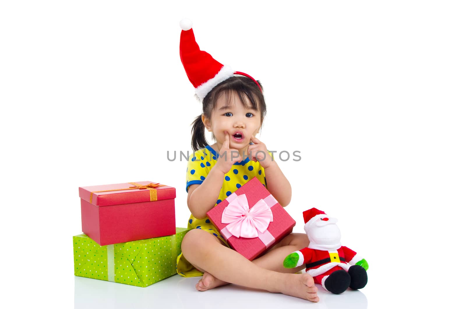 Little Asian girl in Santa hat and Christmas gift box isolated on white