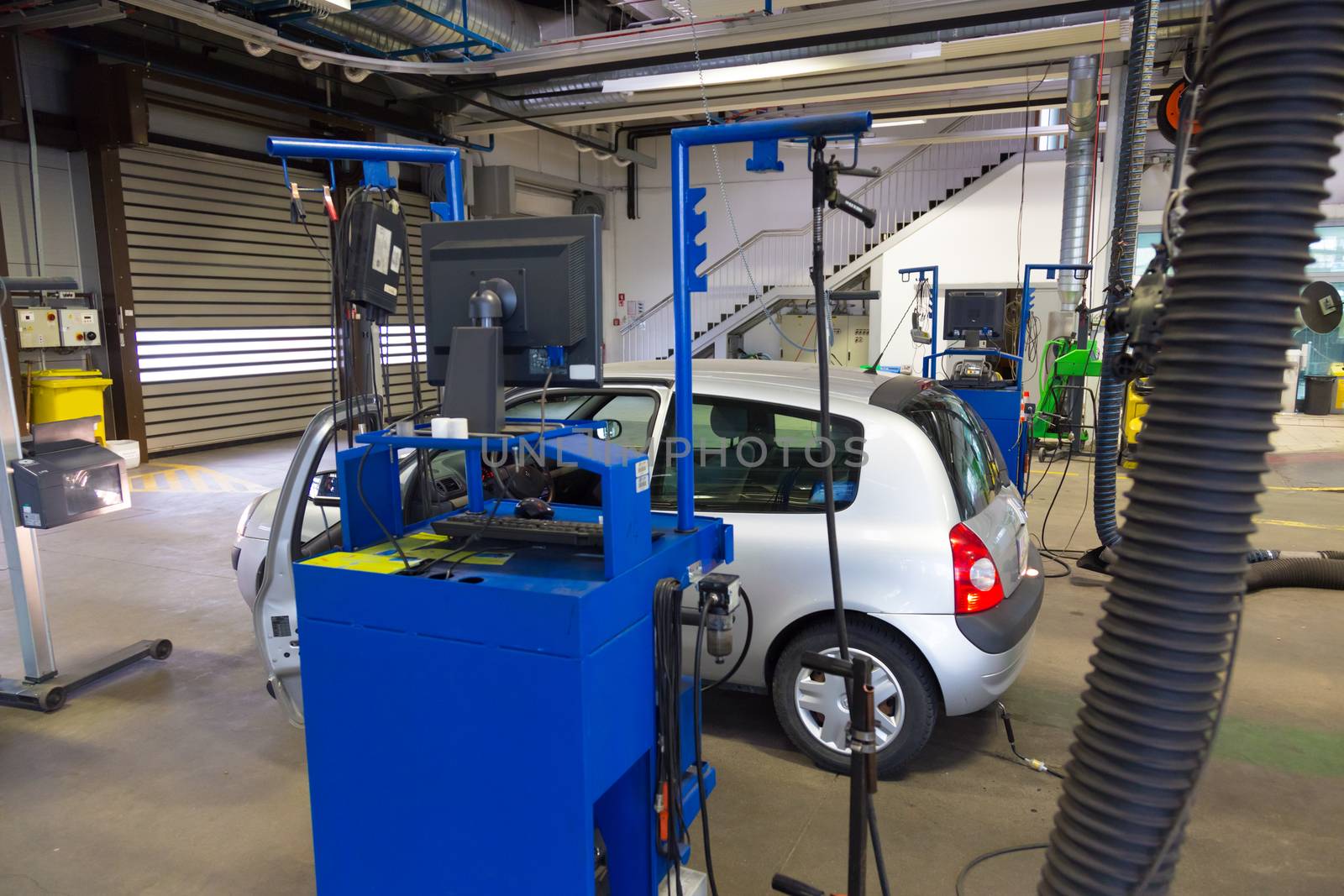 Car waiting for lights inspection and pollution measurements ontechnical review in car repair shop.