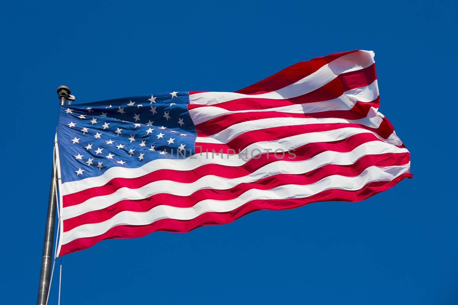 American flag on the blue sky, USA, special photographic processing.