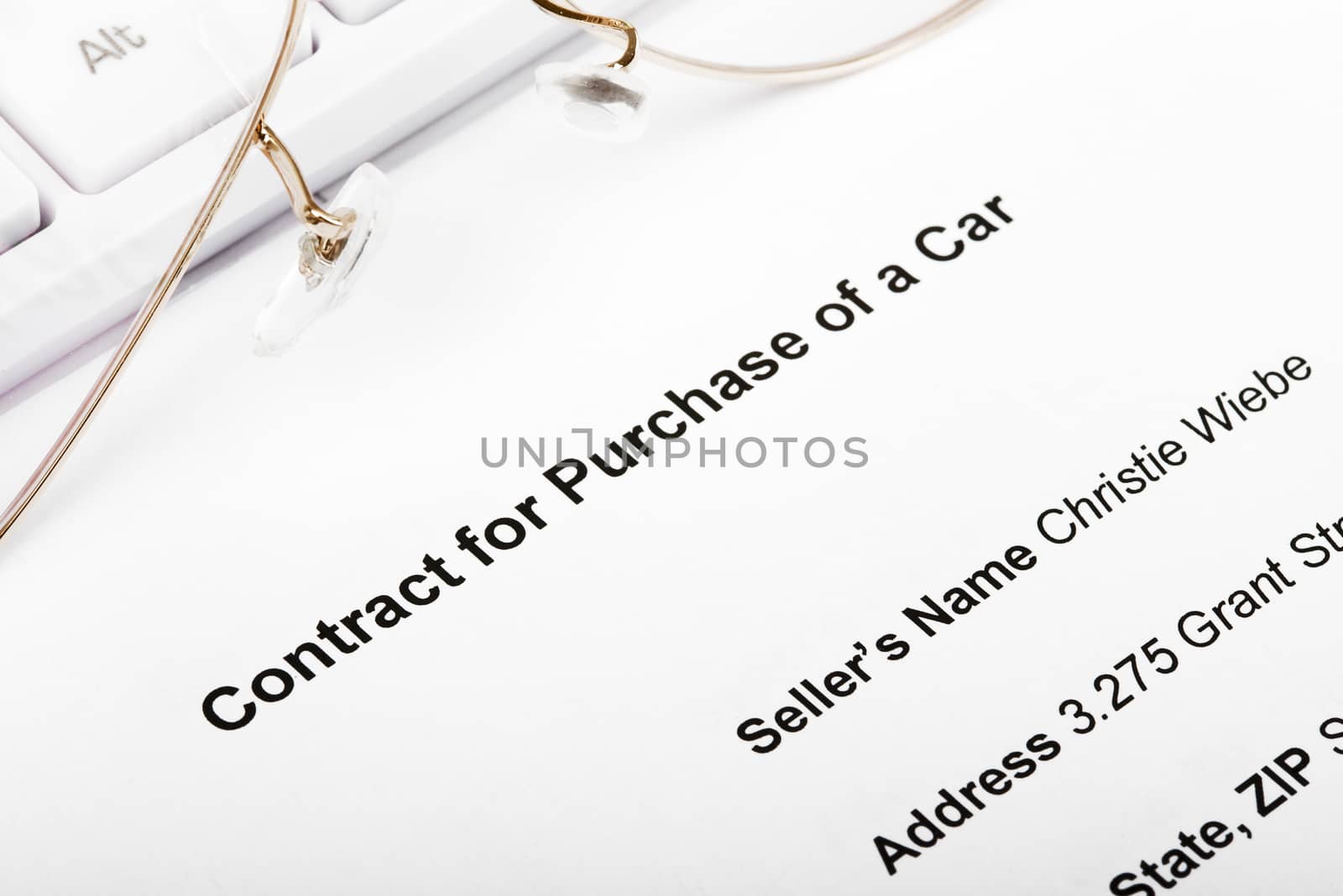 Keyboard with eyeglasses and contract for purchase of car