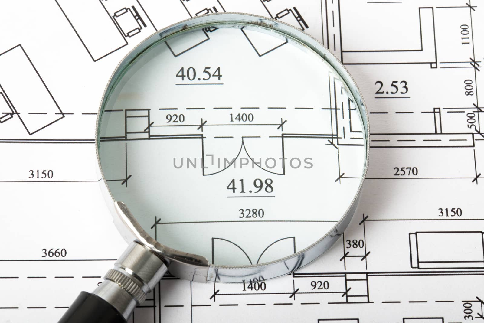 Magnifier on blueprints with numbers, close up view