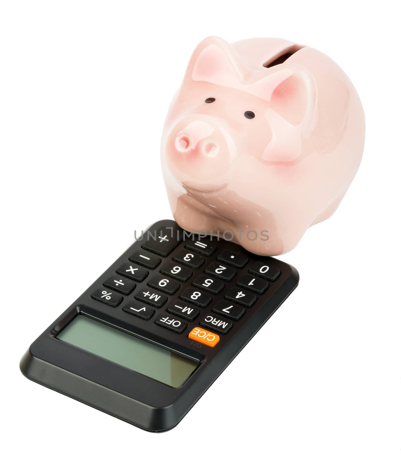 Piggy bank on calculator isolated on background, close up view