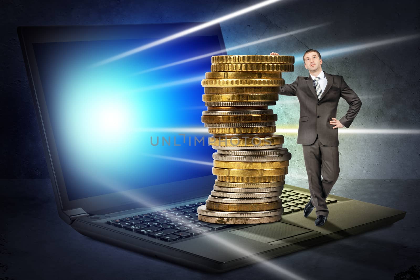 Businessman with big stack of coins on latop by cherezoff