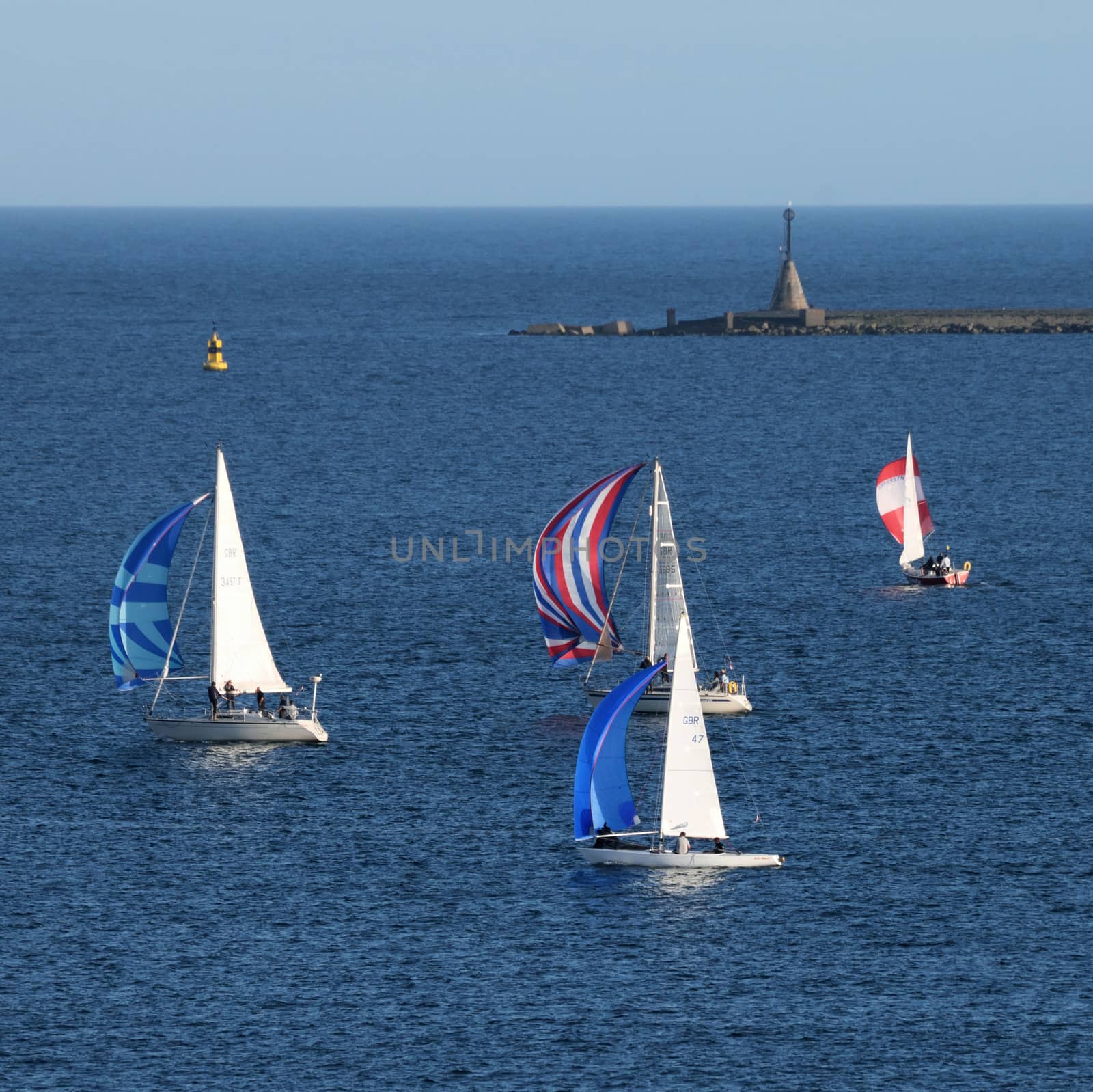 Sailing vessels in race around Plymouth Sound, Devon, UK, mid summer evening.