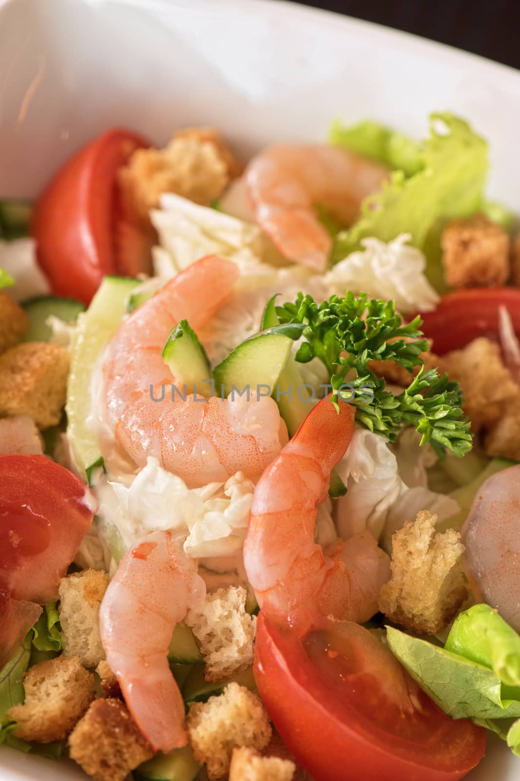 Caesar shrimp salad with cheese and arugula