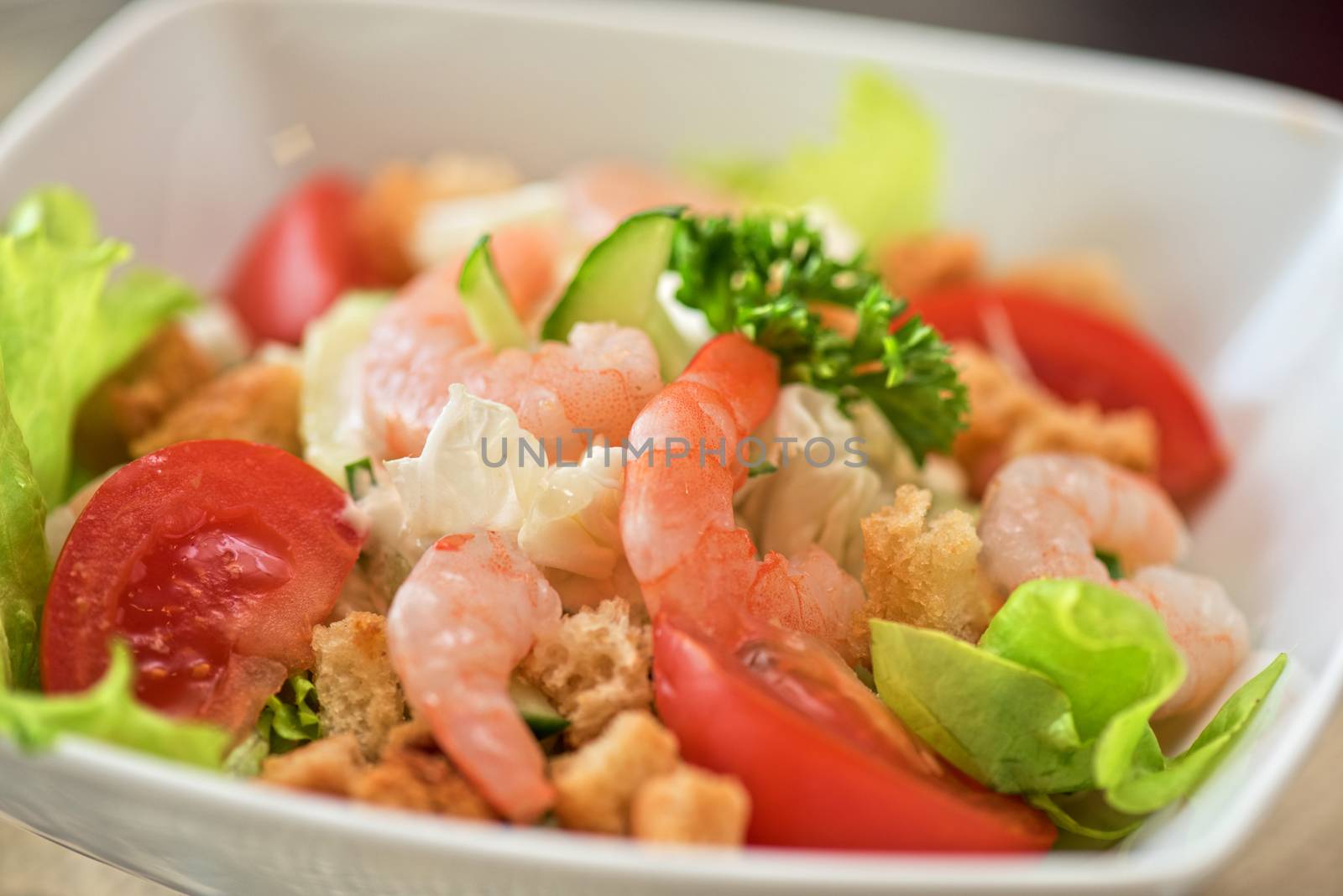 Caesar shrimp salad with cheese and arugula