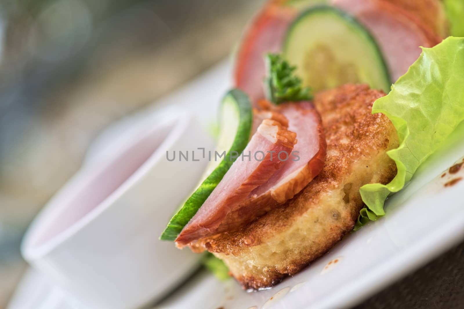 pancakes with ham and cucumber with tomato sauce and lettuce
