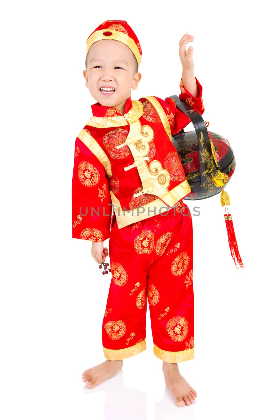 Chinese young boy in traditional Chinese cheongsam , isolated on white background