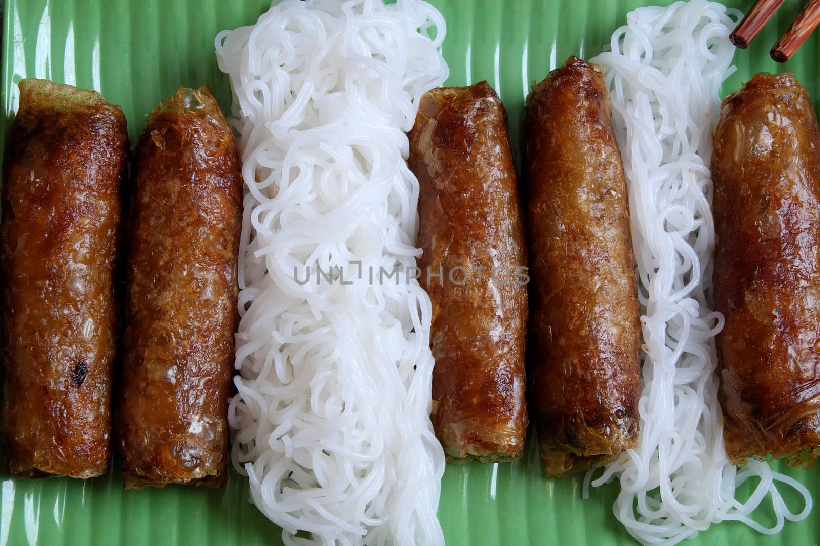 Vietnamese food, spring roll or cha gio, a delicious fried food with cylinder shape, eat with bun, salad and fish sauce, this also rich calories, cholesterol, fatty food, popular Vietnam eating