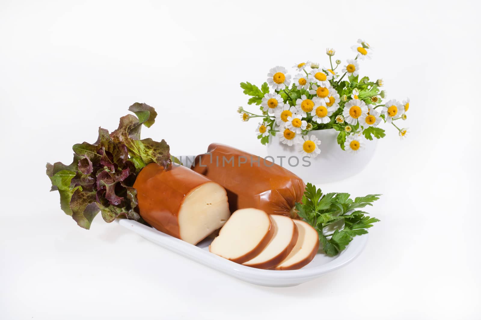 Cheese and camomiles on an isolated studio background