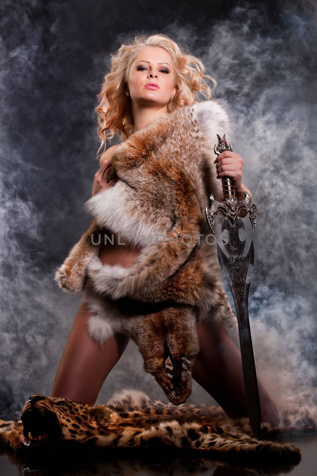 Young beautiful naked woman in fur