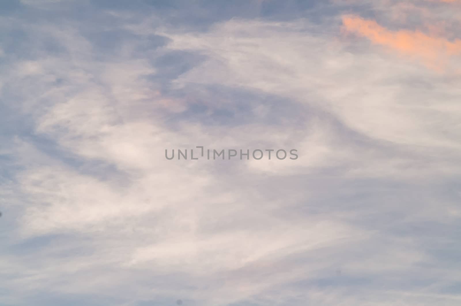 Autumn red gray clouds in the blue sky during the autumn sunset