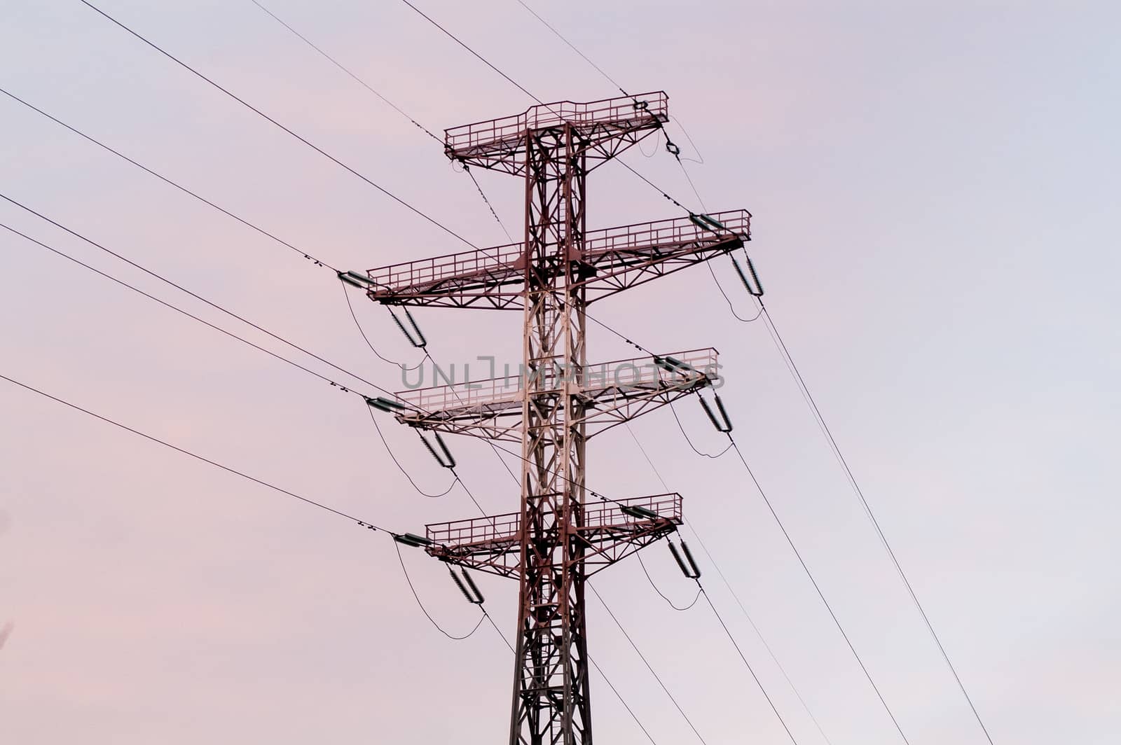 Bearing high-voltage power lines on a red sunset