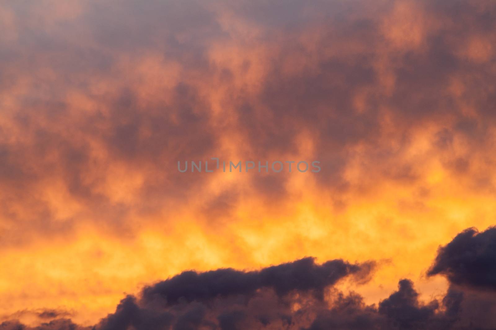 Beautiful fiery clouds at a sunset in the summer afternoon