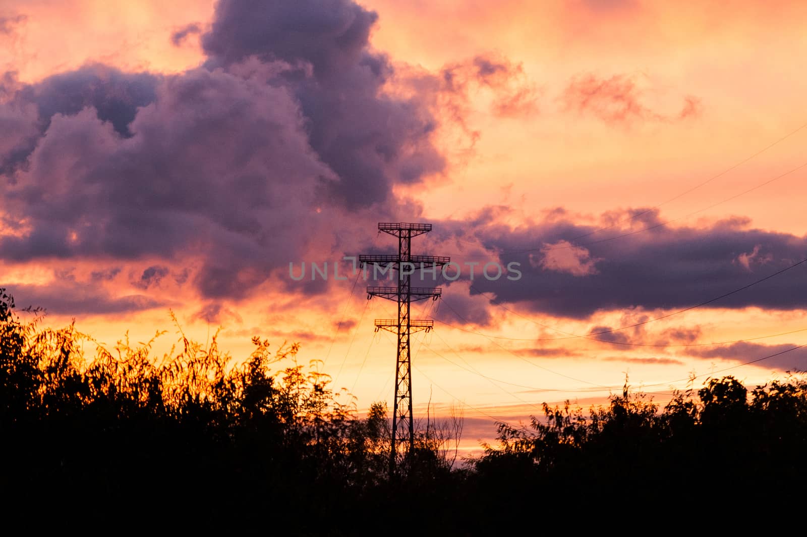 Bearing high-voltage power lines on a red sunset