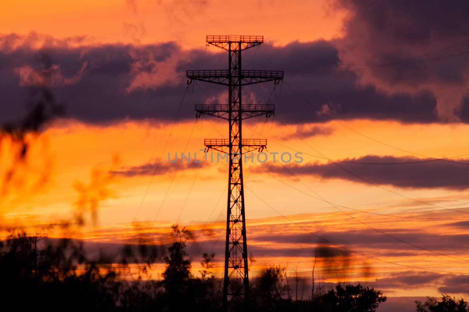 Bearing high-voltage power lines on a red sunset