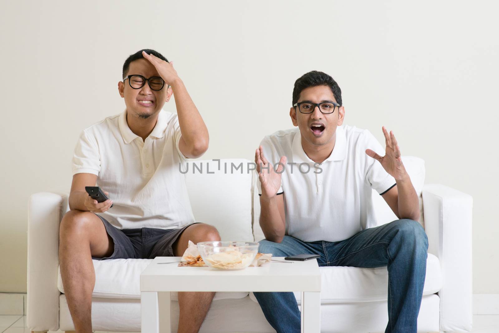 Friendship, sports and entertainment concept. Male friends watching sports together on tv at home.